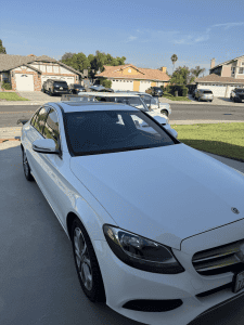 White Mercedes-Benz C-Class sedan after a mobile detail in Moreno Valley, California.