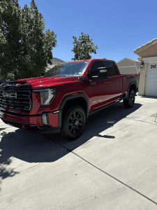 Red GMC Sierra 2500HD truck detailed and polished by Luxury Auto Detailing in Beaumont, CA, ceramic coating available for maximum paint protection.