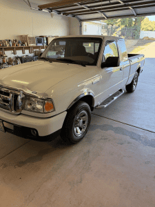 White Ford Ranger pickup freshly cleaned and detailed inside a garage in Beaumont, CA by Luxury Auto Detailing, with ceramic coating service available.